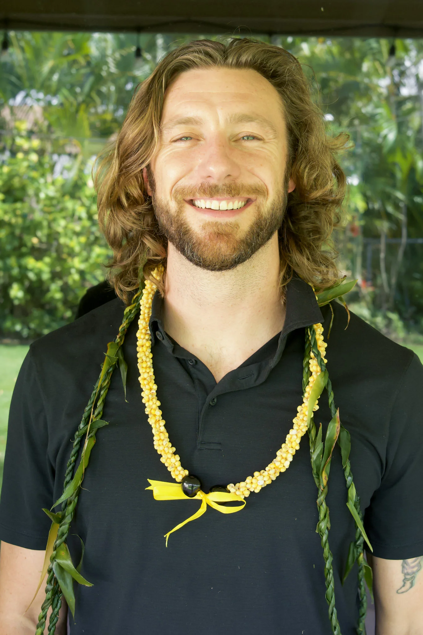Chase Webb, founder of PaperChase Talent, wearing a lei